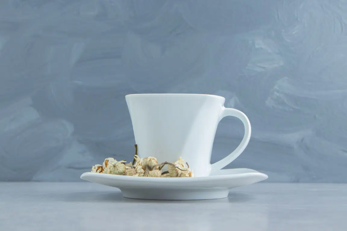 cup of tea with dried chamomile flowers